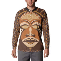 Brown long-sleeve button sweatshirt with tribal face mask print on front and dark collar