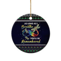 Round dark blue ceramic ornament with gold hanging loop, dragonfly graphic and “As long as I breathe”.