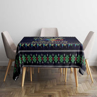 Black tablecloth with multicolor patterned border and central angel graphic on dining setup