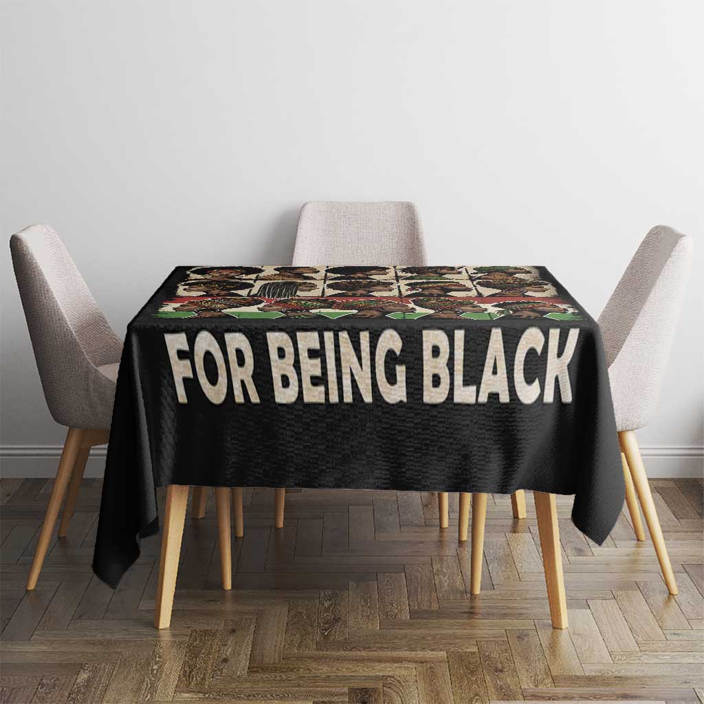 Black tablecloth with 'FOR BEING BLACK' slogan over square dining table