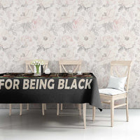 Black African portrait tablecloth with 'FOR BEING BLACK' slogan on dining table