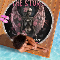 Round black beach blanket featuring winged skeleton, roses, and lightning accents with white fringe