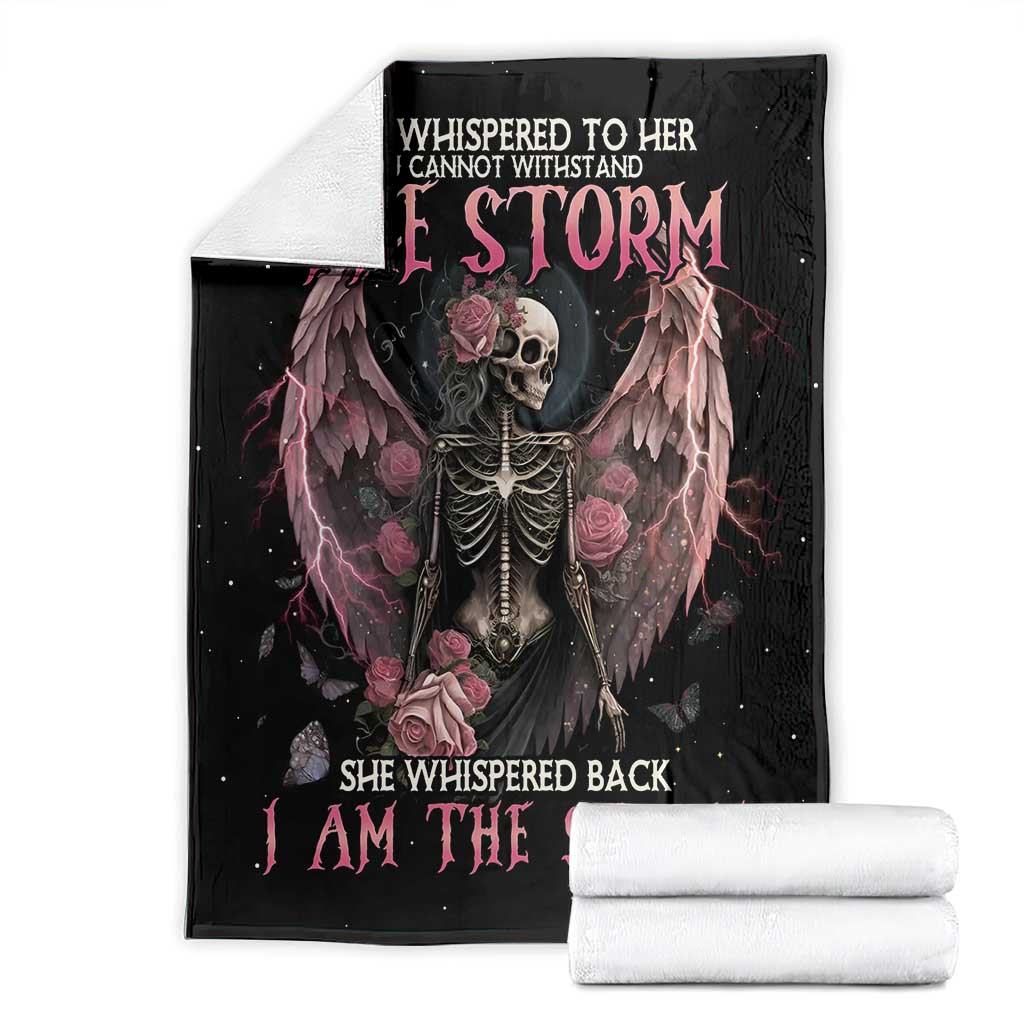 Black skeleton rose wings blanket with pink text, folded and stacked with white rolls