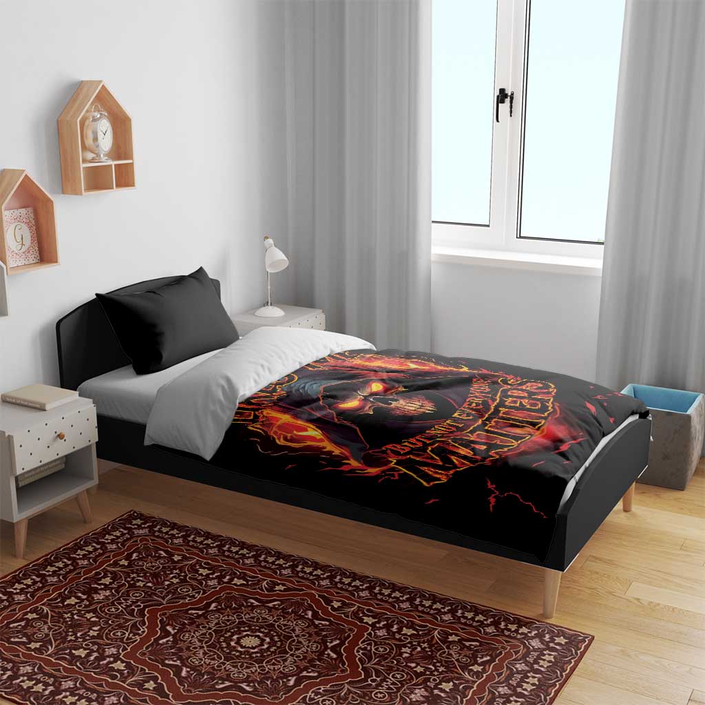 Black bedding set with flaming skull and fiery text graphic on duvet, on a bed setup