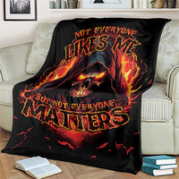 Black skull reaper graphic blanket with flaming skull and glowing red-orange lettering, draped