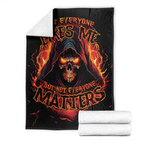 Black skull reaper graphic blanket with flaming skull and glowing red-orange lettering, folded