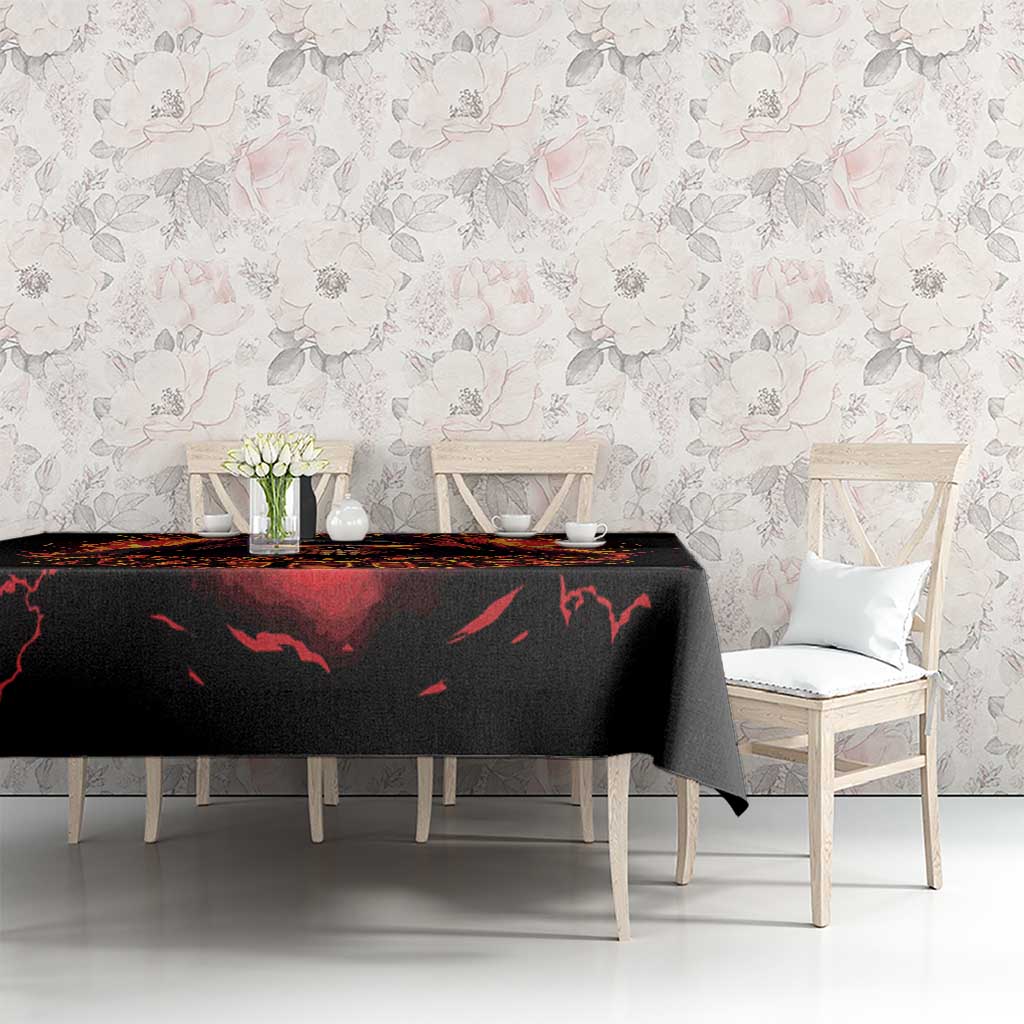 Black tablecloth with flaming skull reaper motif across dining table, side view