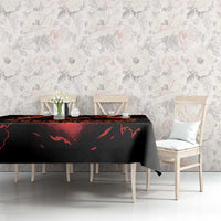Black tablecloth with flaming skull reaper motif across dining table, side view