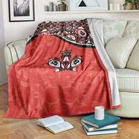 Red throw blanket with black-and-white maple leaf tattoo design