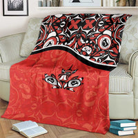 Red blanket with black border stripe and centered maple leaf tattoo motif