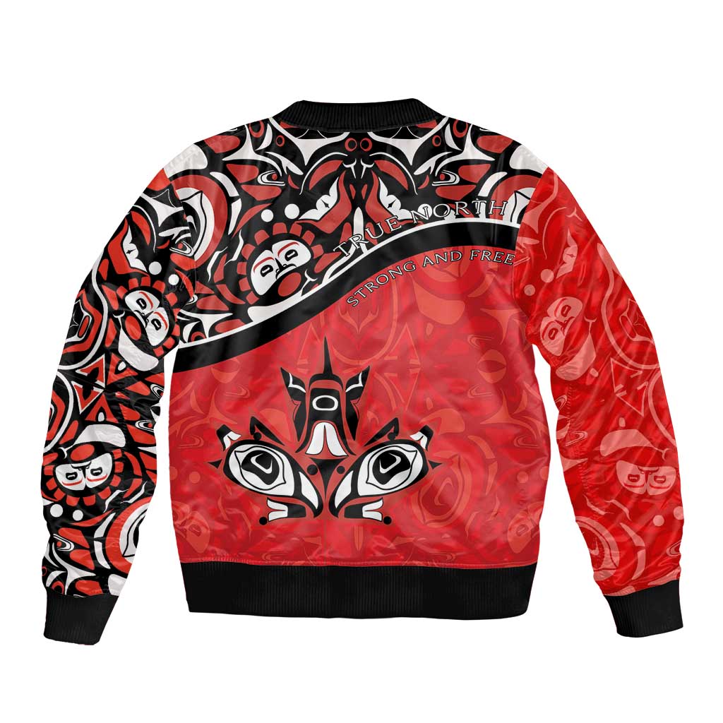 Red unisex bomber jacket with black trim, bold central Haida-style face and 'Strong and Free' text