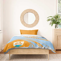 Light blue duvet with orange curved stripes, ANGUILLA text, and crest shield on bed