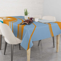 Blue and orange tablecloth draped on dining table with coat of arms crest