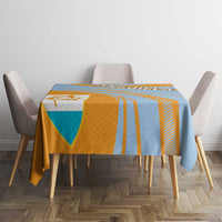 Blue, orange, and yellow tablecloth with cricket stripes and coat of arms emblem