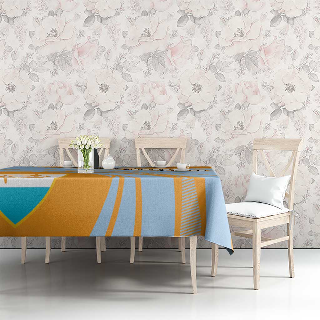 Blue and orange tablecloth with diagonal stripes and coat of arms crest on table