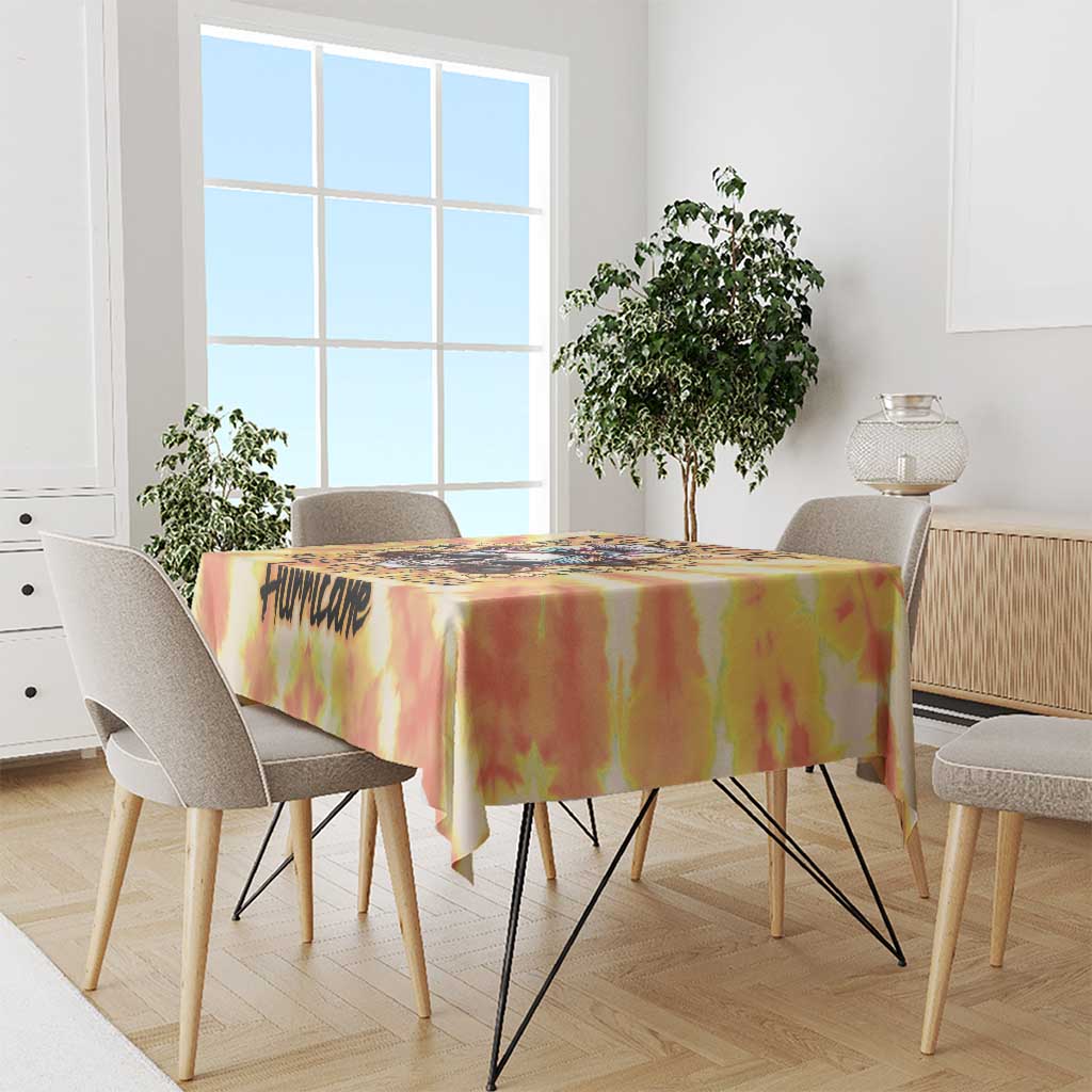Tie-dye tablecloth in yellow, orange, and red over a dining table