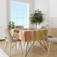 Tie-dye tablecloth in yellow, orange, and red over a dining table