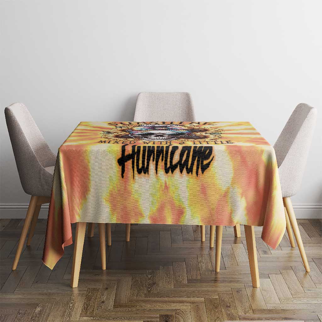 Yellow tie-dye tablecloth with centered black 'Hurricake' graphic on a dining table