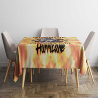 Yellow tie-dye tablecloth with centered black 'Hurricake' graphic on a dining table