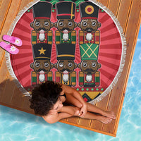 Red round beach blanket showing six nutcracker faces with white fringe edge