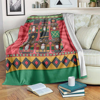 Red and green nutcracker blanket with stacked character faces and patterned hem