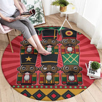 Red round nutcracker rug with rows of cartoon nutcracker faces and multicolor border