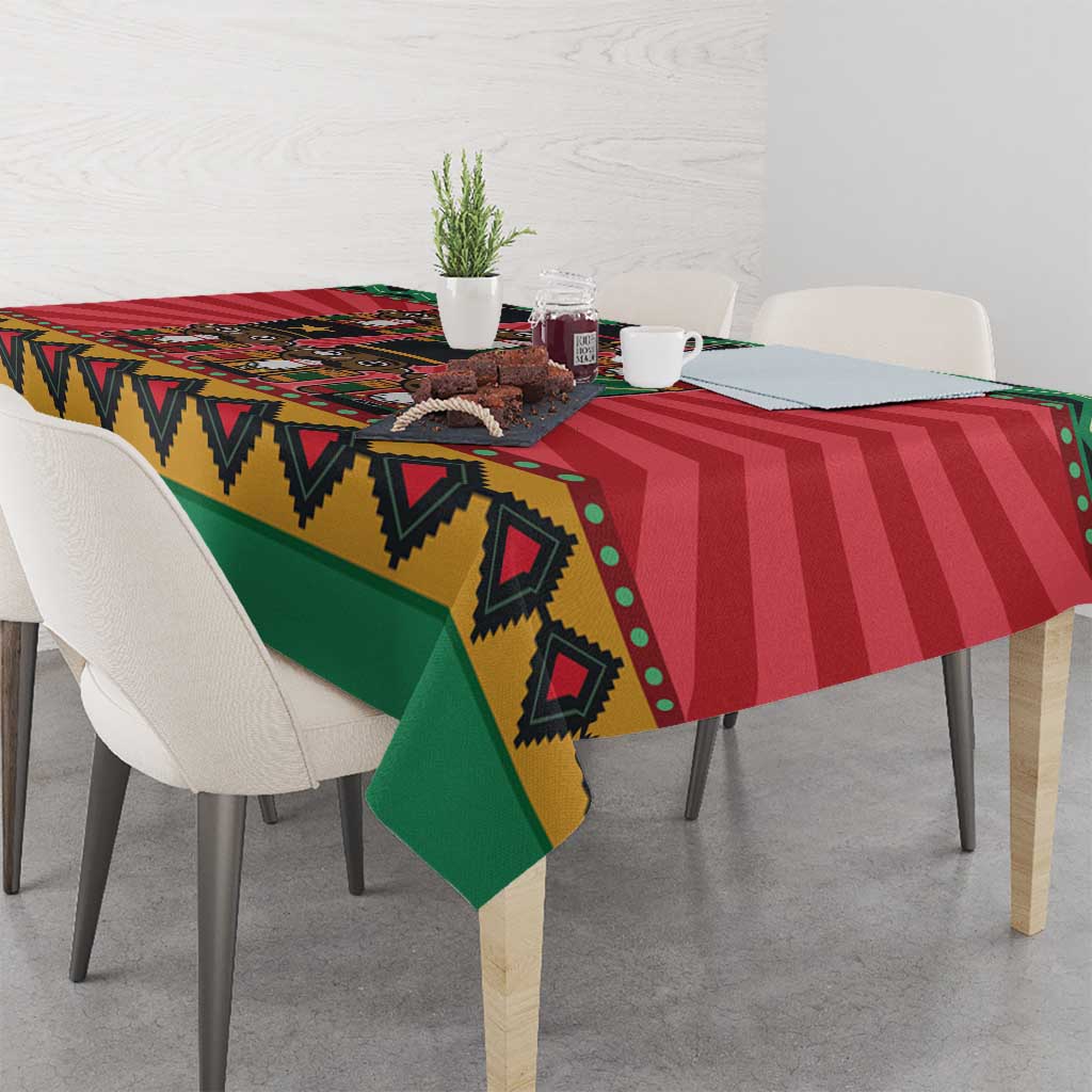 Red, green, and gold tablecloth with nutcracker design and geometric border on table.
