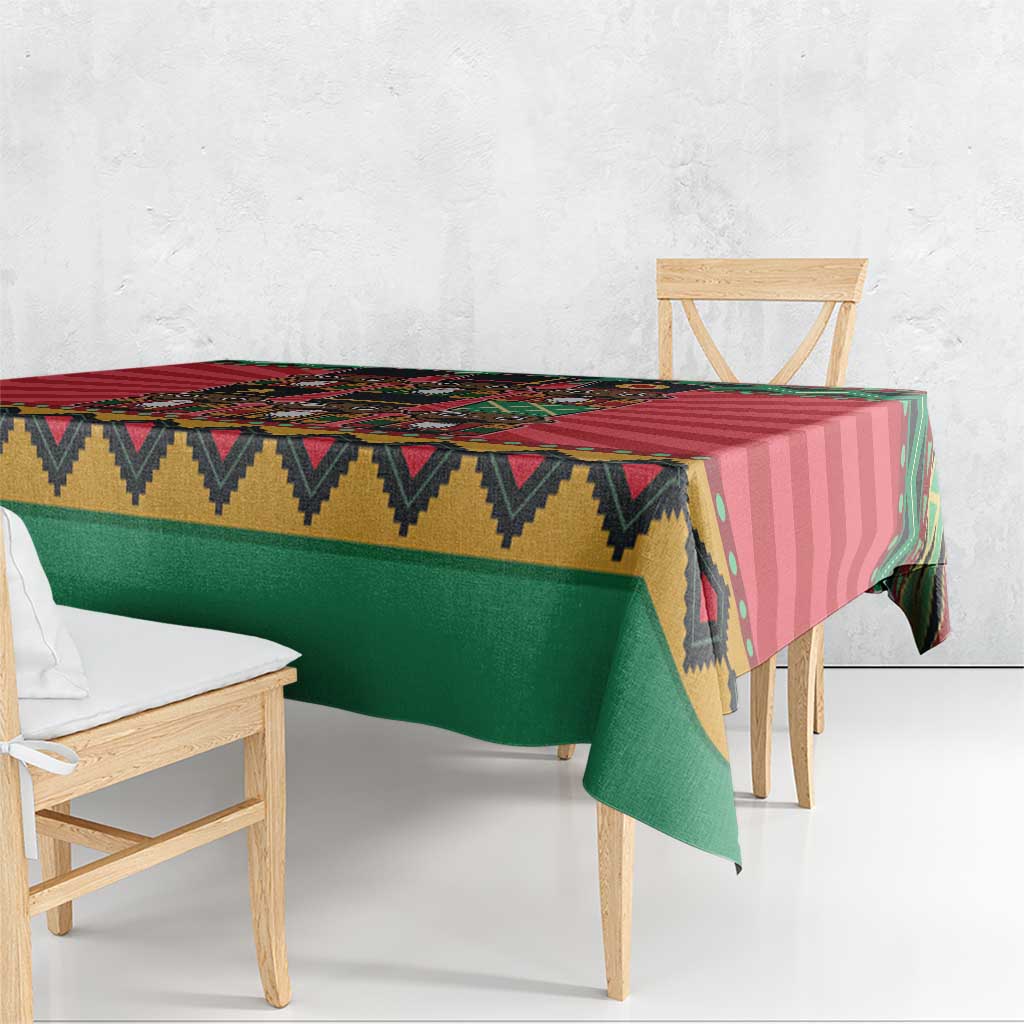 Corner view of red and green Christmas tablecloth with patterned edge and drape.