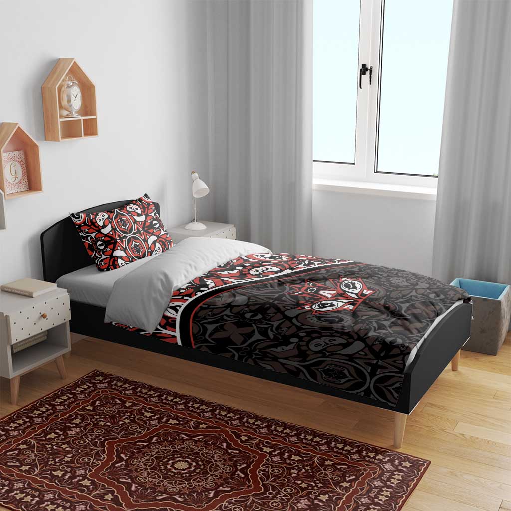 Black duvet set with red and white tribal maple-leaf pattern on bed with two pillows