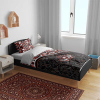 Black duvet set with red and white tribal maple-leaf pattern on bed with two pillows