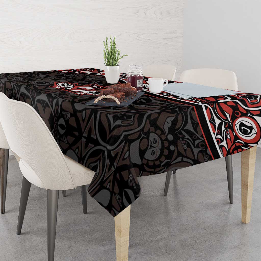 Black tablecloth with red and white Haida-style tattoo maple leaf pattern on dining table