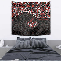 Black tapestry with red and white central maple leaf emblem and ornate geometric motifs