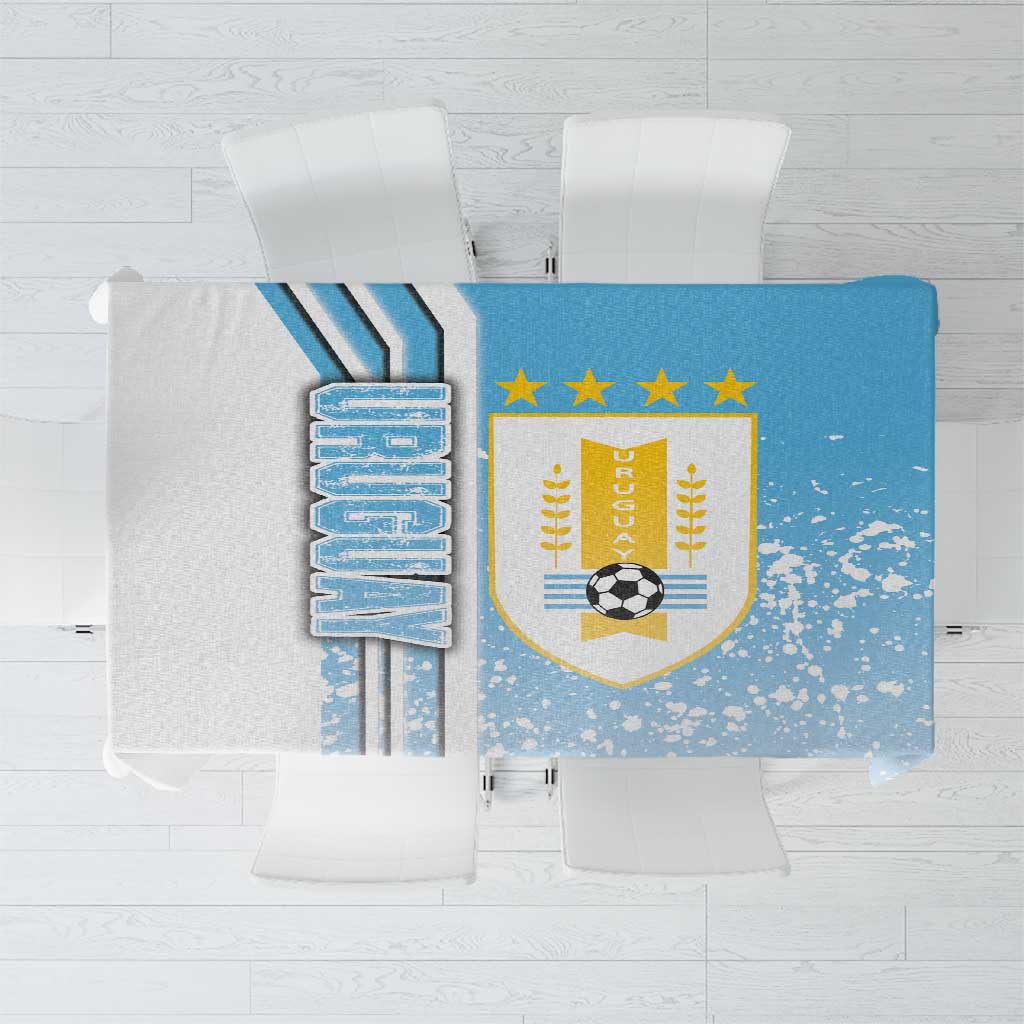 Sky blue Uruguay soccer tablecloth with crest and star accents, rectangular design.
