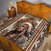 Native American style quilt blanket laid on bed with dreamcatcher and feathered portrait