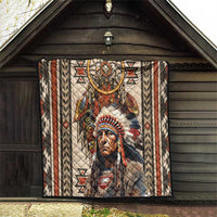 Native American style quilt blanket hanging on wall with dreamcatcher and headdress print