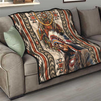Native American style quilt blanket on sofa with dreamcatcher, feathers, and portrait