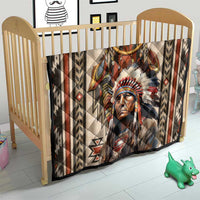 Native American style quilt blanket on baby crib with dreamcatcher and feather headdress print