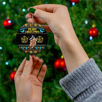 Ceramic cowboy Merry Christmas circle ornament with gold cowboy, stars, and 'MERRY CHRISTMAS'.