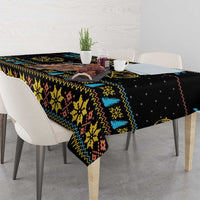 Rectangular Christmas tablecloth with dark base, zigzag stripes, snowflake motifs, and yellow details