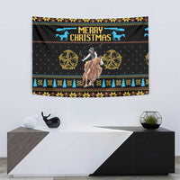 Christmas tapestry showing cowboy on horse, “Merry Christmas” title, and star medallions