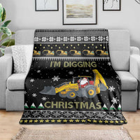 Folded black Christmas throw blanket with tractor, Santa, snowflake and evergreen trim
