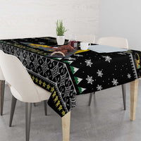 Black patterned tablecloth with tractor graphic, snowflakes, and triangle accents