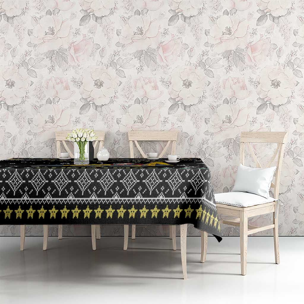 Black tablecloth with repeating geometric pattern, yellow stripe, and snowflakes