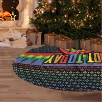 Black Christmas tree skirt with rainbow graphic and fringed edge