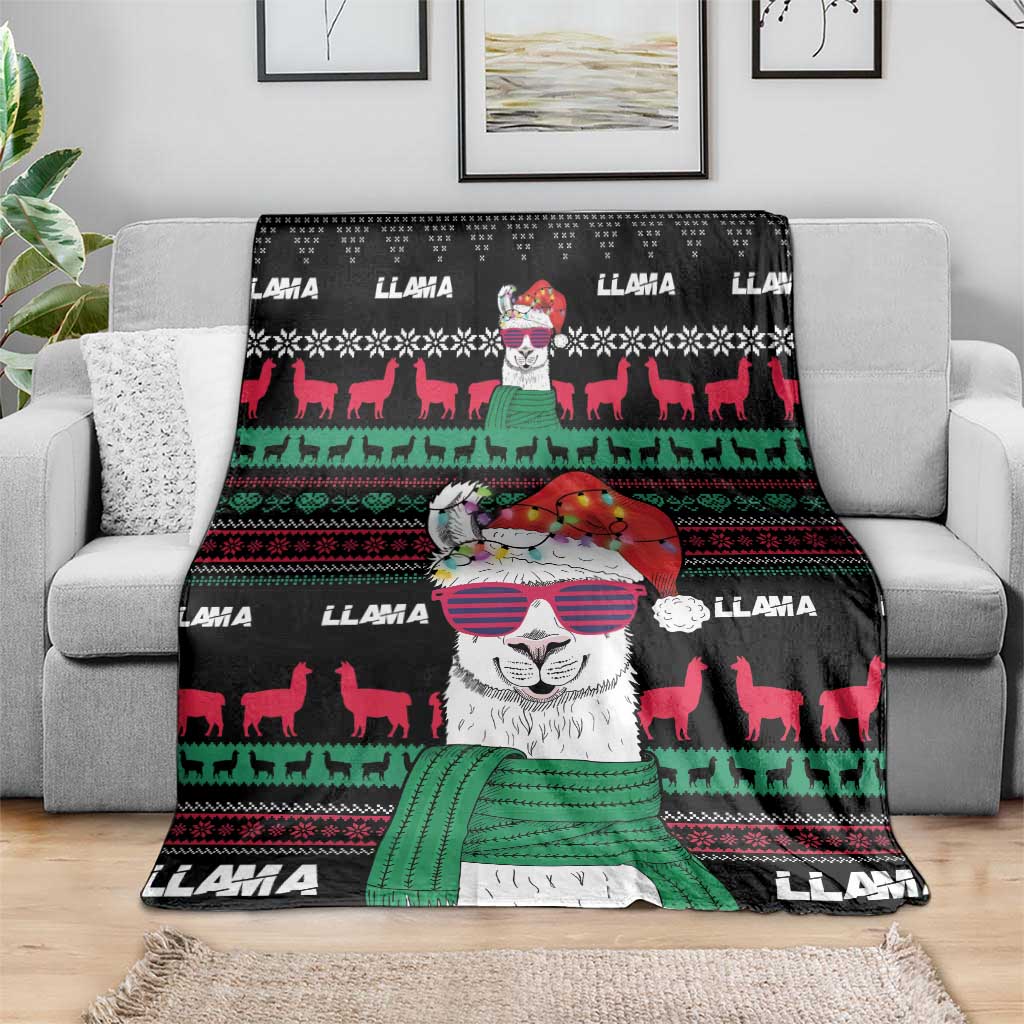 Black Christmas llama blanket draped on sofa with large llama face and red-green geometric stripes.