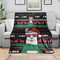 Black Christmas llama blanket draped on sofa with large llama face and red-green geometric stripes.