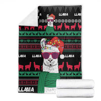 Black llama blanket with central llama character, red and green festive bands and deer silhouettes.