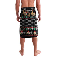 Black printed lava lava sarong featuring cartoon sloths, trees, and candy-cane trim