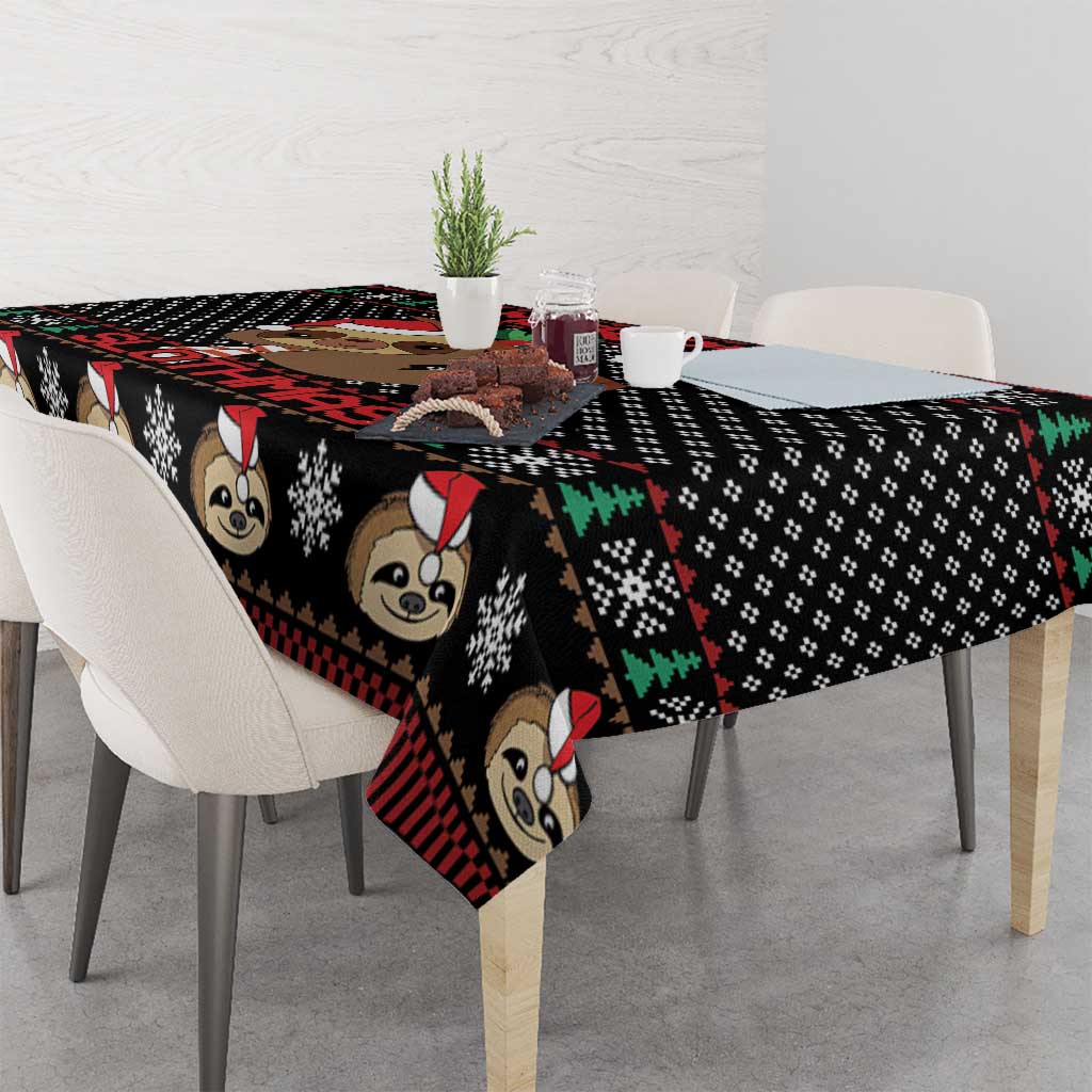 Black tablecloth with repeated sloth faces, red plaid edge, and snowflake dots