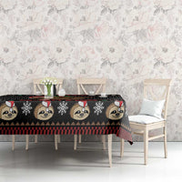 Black sloth Christmas tablecloth with repeating animal faces and festive check stripe